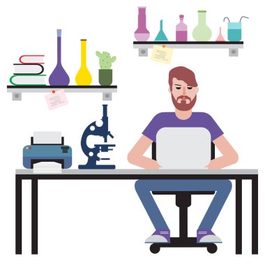 Masada oturan ve dizüstü bilgisayarda çalışan adam.