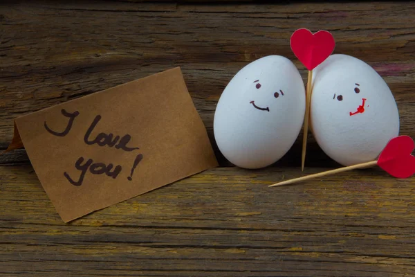 The love of two eggs, red hearts and card