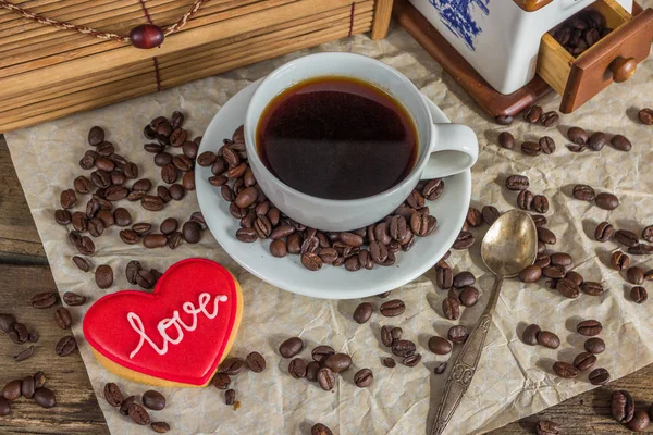 Valentine red cookie with heart shape, cup of coffee, beans and — Stock Photo, Image