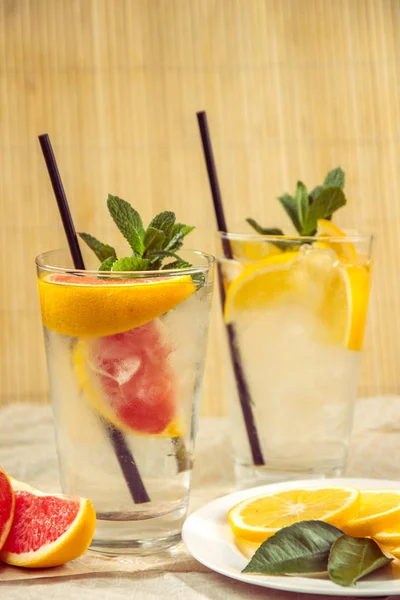 Два стакана воды с красным апельсином, лимоном, мятой и льдом. Fr — стоковое фото