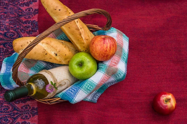 Picknickmand op het bovenaanzicht van de rode deken. Appels, witte wijn een — Stockfoto