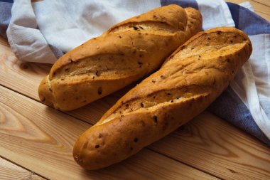 Ahşap arka plan üzerinde iki baget. Masaya loafs