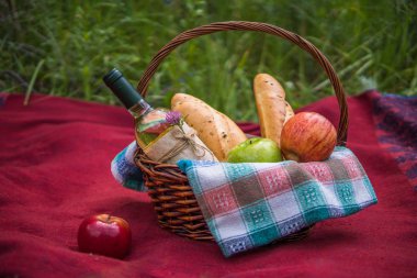 Doğa, kırmızı paket üzerinde piknik sepeti. Elma, beyaz şarap bir