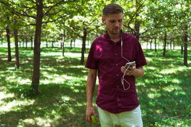 Yaz Park cep telefonu olan bir adam. Sm ile yakışıklı delikanlı