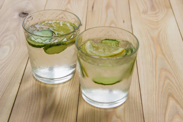 Desintoxicar a água com pepino e limão na mesa de madeira. Cucumber le — Fotografia de Stock