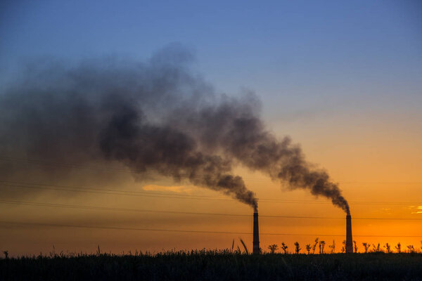 Промышленный дым из трубы на закате, степь под Алматы, Каз
