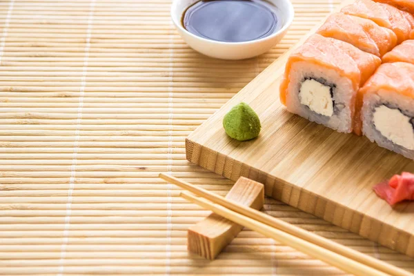Sushi philadelphia roll on a wooden board. Japanese cuisine
