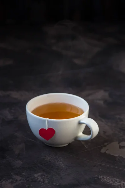 Cup of tea with heart shaped teabag tag