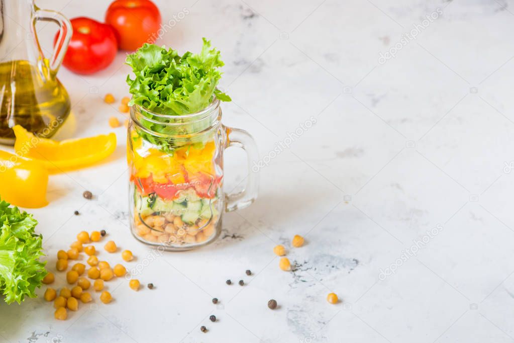 Salad in a jar. Homemade healthy salad from chickpea, tomato, ye