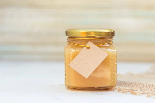 Honey in jar with empty paper label for your text