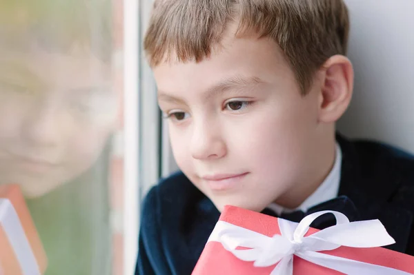 Happy Little Boy Jacket Sitting Window Holding Gift — Stock Photo, Image