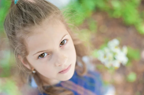 Portrait of a beautiful little pensive girl looking at the camera — Stock Photo, Image