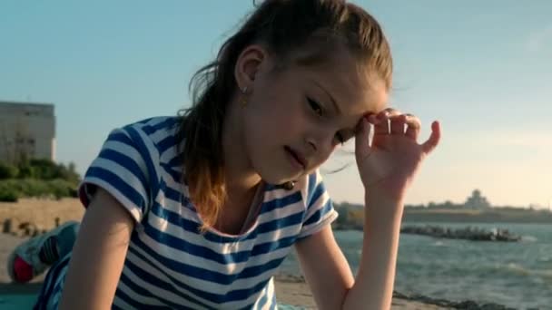 Lovely Young Girl Lies Beach Looking Ocean Playing Pet Fish — Stock Video