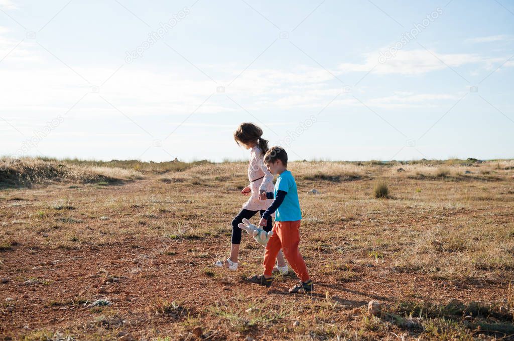 poor refugees children walking across desert escaping war conflict