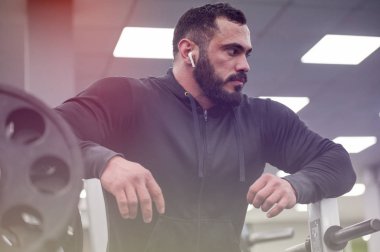 healthy strong young bearded tired sport mindful man during rela