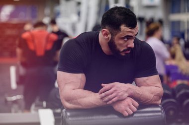 sport motivation concept of strong young bearded man relaxing am