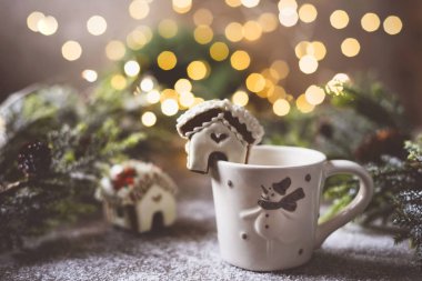 Bir chpshka 'nın üzerinde minyatür zencefilli kurabiye evi bir Noel ağacının arka planında. 