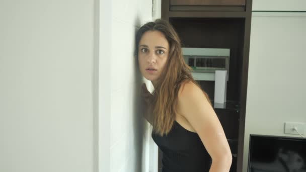 Bella donna che guarda attraverso lo spioncino della porta. Terrorizzato giovane donna 4k — Video Stock
