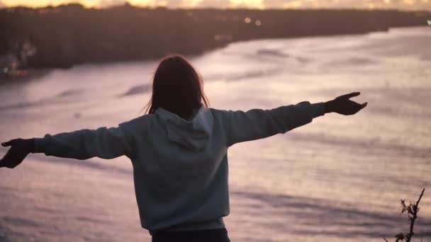 Primer plano retrato de una hermosa joven mirando hacia arriba explorando mindfulness contemplando la espiritualidad con el viento soplando pelo disfrutando de la tranquila playa al atardecer 4k — Vídeo de stock