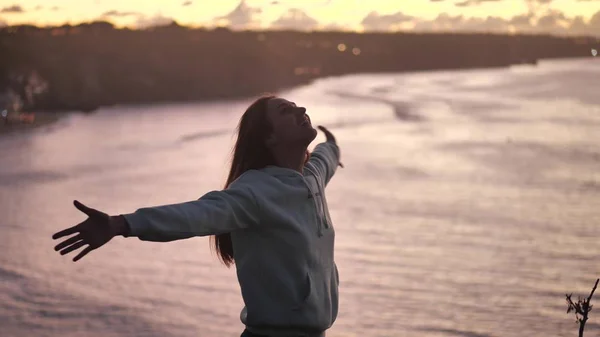 close up portrait of beautiful young woman looking up exploring mindfulness contemplating spirituality with wind blowing hair enjoying peaceful seaside at sunset 4k