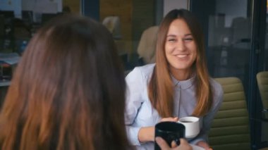 close up portrait girl with a dimple talks to her friend