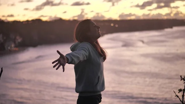 close up portrait of beautiful young woman looking up exploring mindfulness contemplating spirituality with wind blowing hair enjoying peaceful seaside at sunset 4k