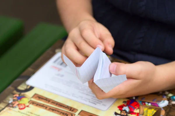 Child\'s hands making paper plane