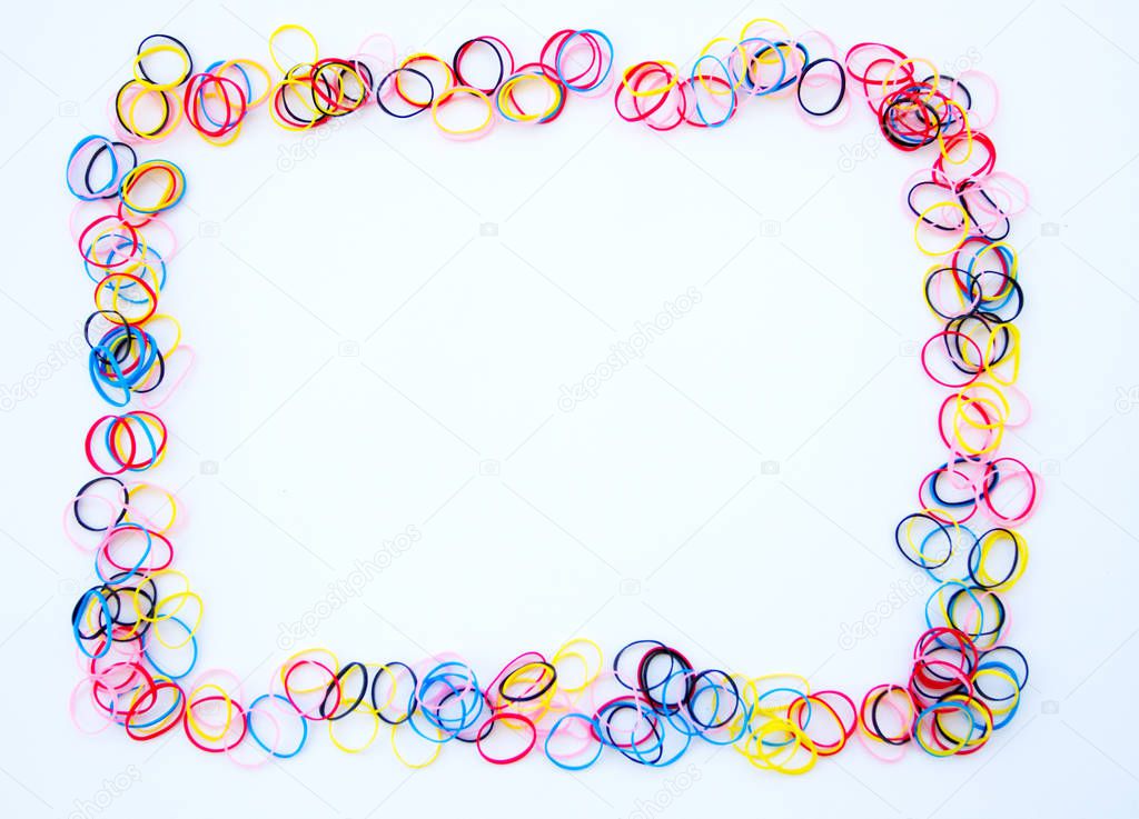 Colorful loom rubber bands frame on white backround