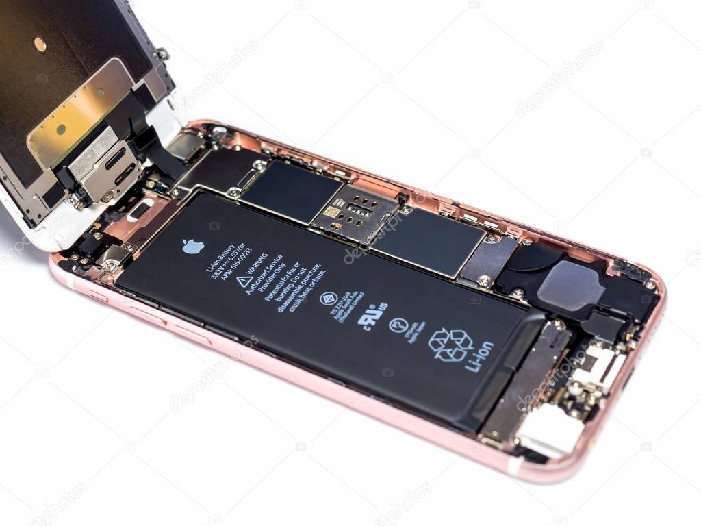 Chiangrai, Thailand: April 8, 2017 - Apple iPhone 6S rose-gold color disassembled for repair and showing components inside on white background . Selective focus