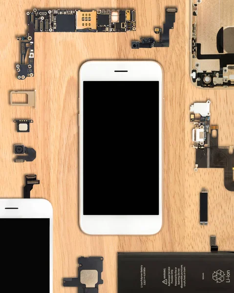 Smartphone components on wooden background — Stock Photo, Image