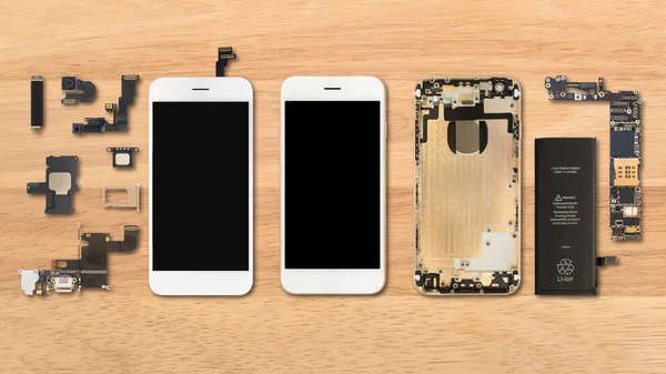 Smartphone components on wooden background — Stock Photo, Image