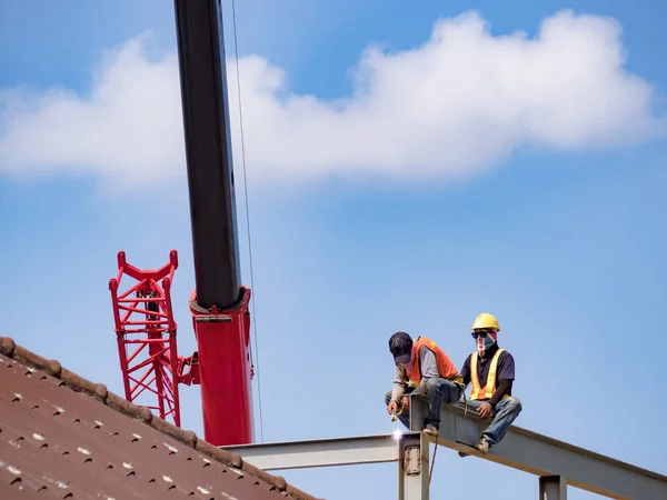 Builder welding on high-rise steel frame