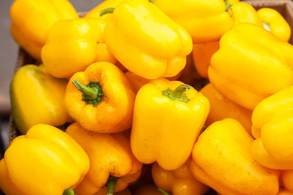 Fresh yellow pepper lying on the market counter.