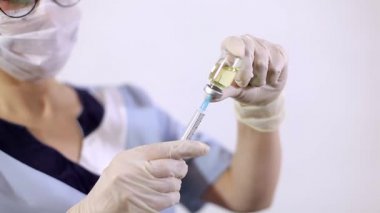 Ellerinde şırınga iğnesi, grip, kızamık, koronavirüs COVID-19 aşısı olan azot eldivenli bir doktor ya da hemşire eli.