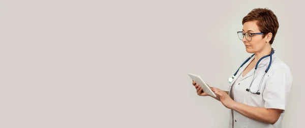 Portret kobiety używającej tabletu cyfrowego. Kobieta lekarz za pomocą tabletek i sprawdzanie z analizą — Zdjęcie stockowe