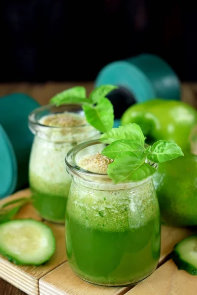 Green cocktail in a glass jar sprinkled with brans decorated with basil