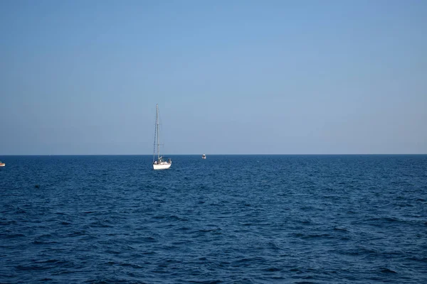 The Black Sea and a boat on the horizon. Seascape with cloudless sky on a sunny day