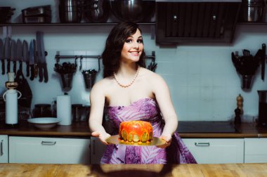 Pasta fondan ile büyük çörek gibi gülümseyen hostes tutar 