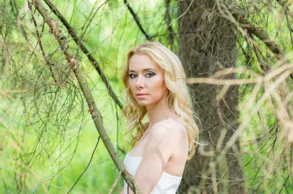 Portrait of young blond bride in forest — ストック写真