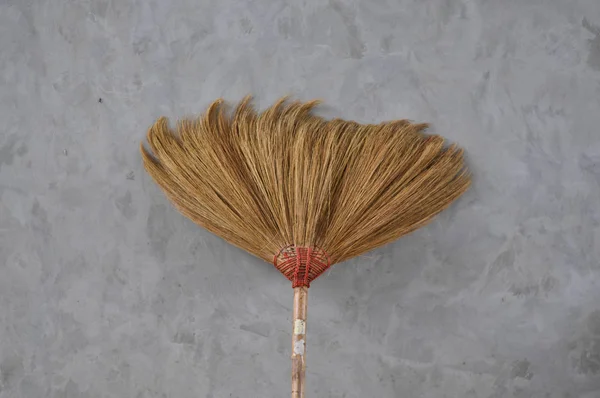 Broom on cement wall — Stock Photo, Image