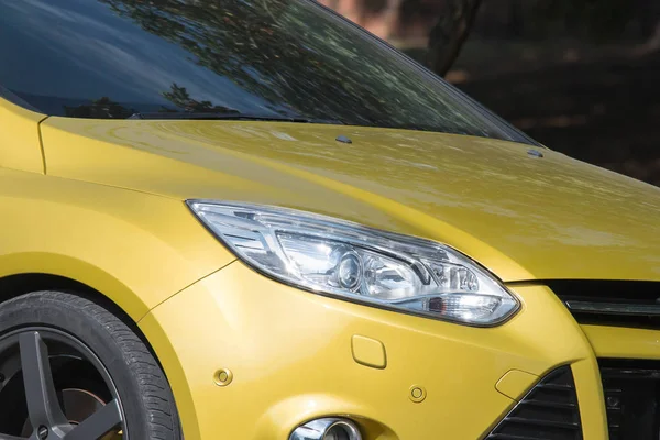Yellow car headlights. Car exterior details