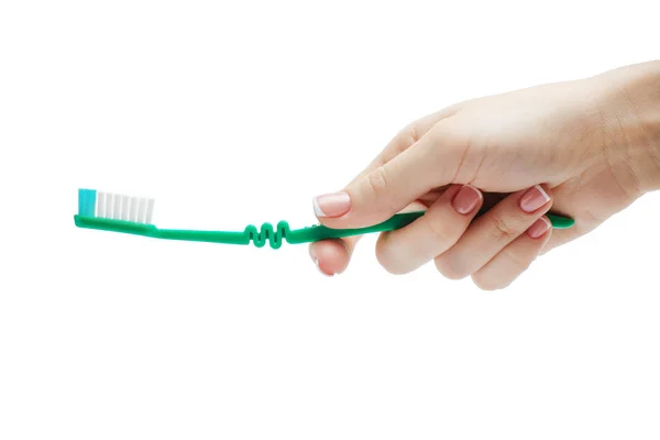 Woman manicured hand holding a toothbrush isolated on white background — Stock Photo, Image