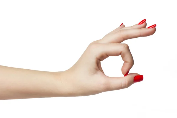 Mujer mano en signo ok con manicura y uñas rojas en un aislado blanco — Foto de Stock