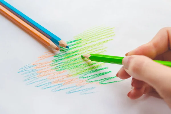 Colored pencils in hand — Stock Photo, Image