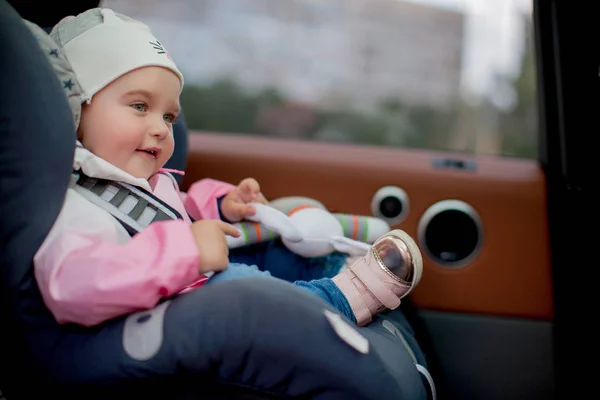 Girl sitting in child seat — Stock Photo, Image