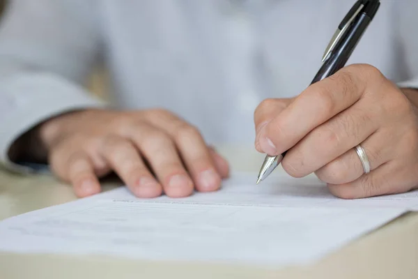 Man writing something on sheet of paper — Stock Photo, Image