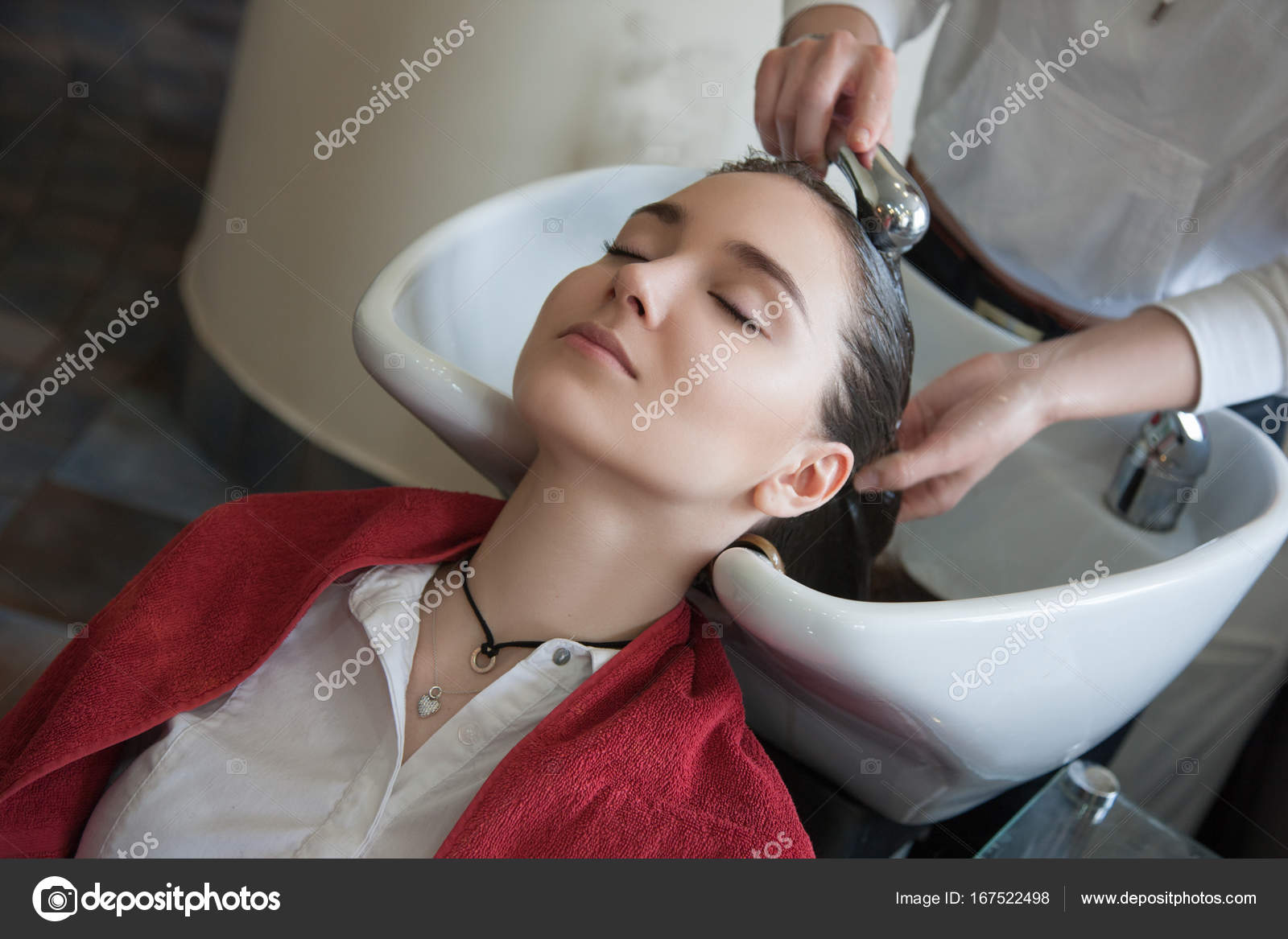 Hairdresser Washing Hair For Customer In Sink Stock Photo