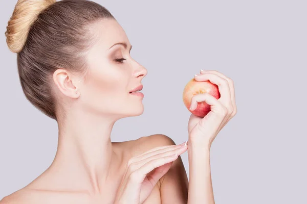 Woman standing with apple — Stock Photo, Image