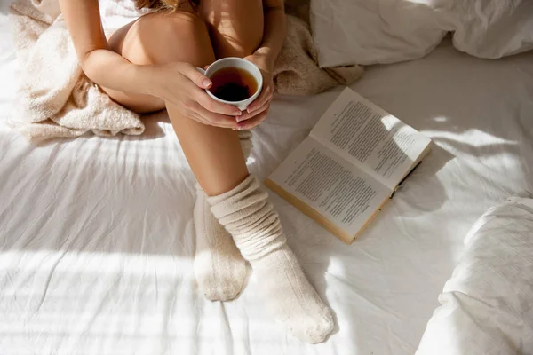 Woman sitting and holding cup of tea