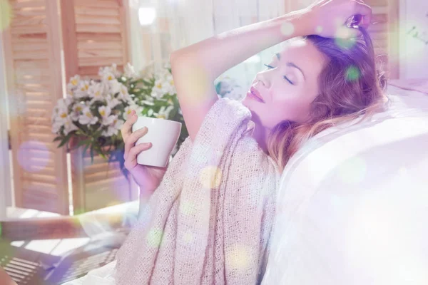 Katta oturan ve yatağın üzerine eğilerek kadın